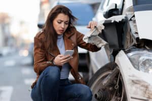 girl beside car after car accident