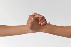 two people holding hands - helping each other